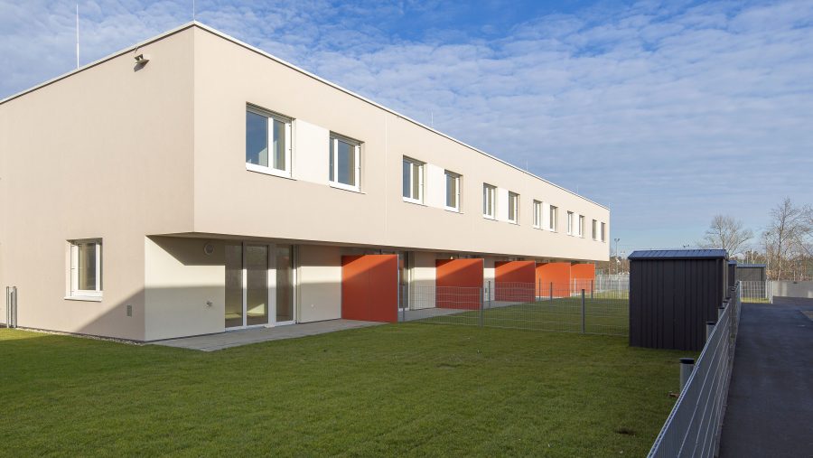 Moderne Gebäude mit Garten und blauen Himmel im Hintergrund.