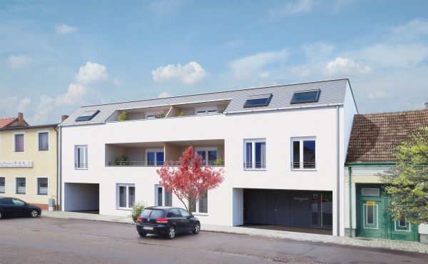 Mehrfamilienhaus mit modernem Design und Balkonen, umgeben von Autos und Bäumen in einer Stadtstraße.