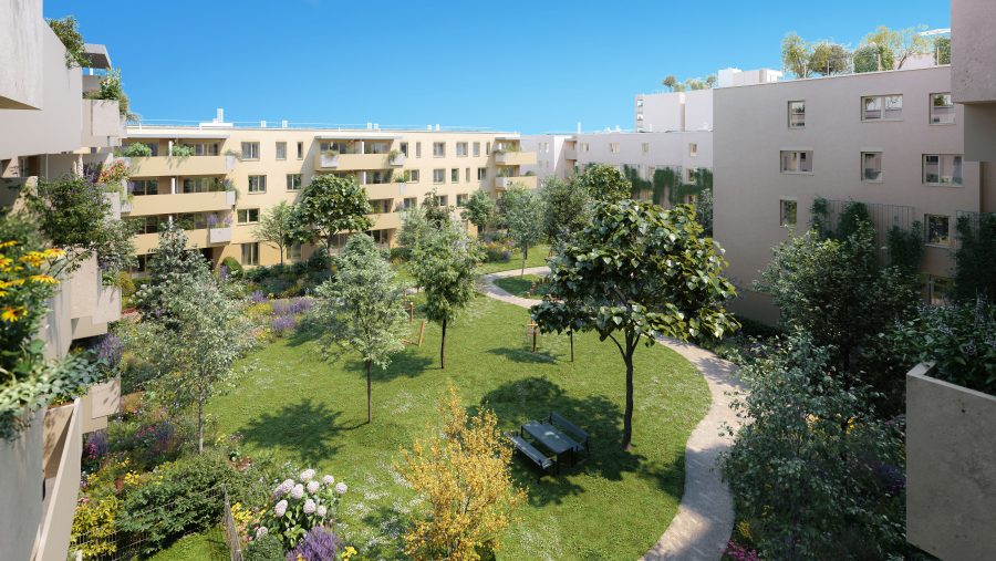 Wohnanlage mit grüner Gartenanlage und modernen Gebäuden im Hintergrund, sonniger Tag.