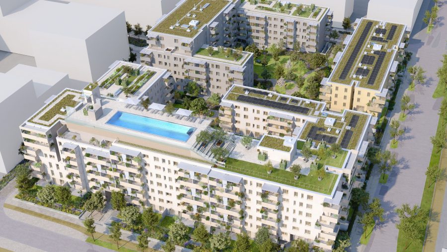 Moderne Wohnanlage mit begrünten Dächern, Solarpaneelen und einem Pool, umgeben von Bäumen und Straßen.