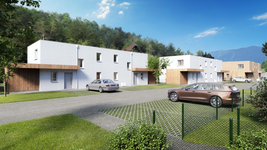 Moderne Wohnhäuser in einer ruhigen, grünen Umgebung mit Autos im Vordergrund und blauen Himmel im Hintergrund.