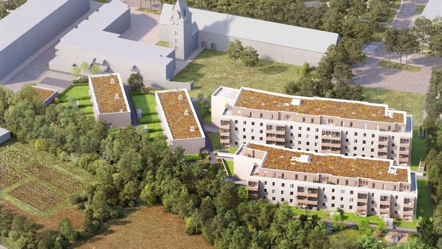 Luftaufnahme eines modernen Wohnkomplexes mit begrünten Dächern und umgebender Natur.