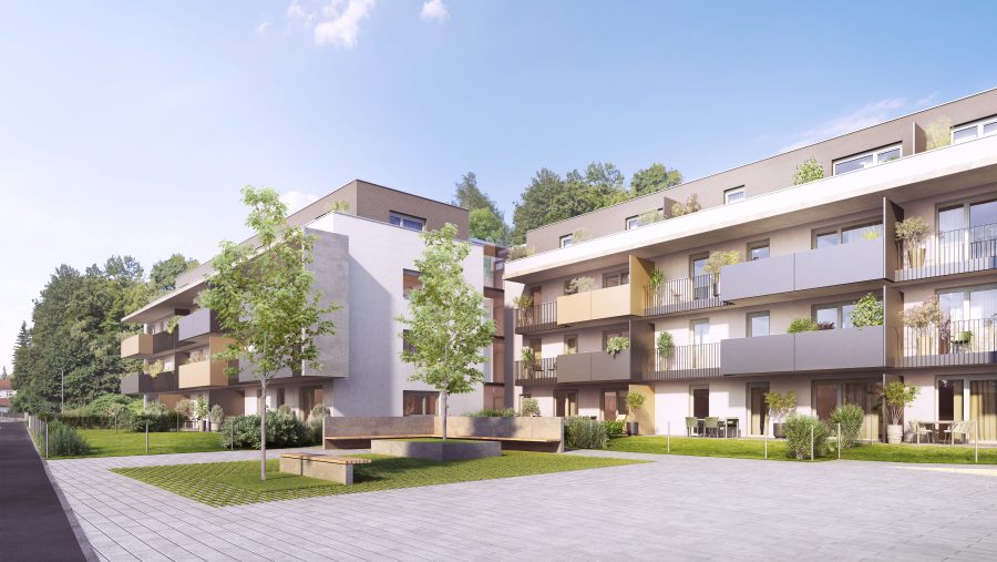 Moderne Wohnanlage mit Balkonen und Grünflächen an einem sonnigen Tag.