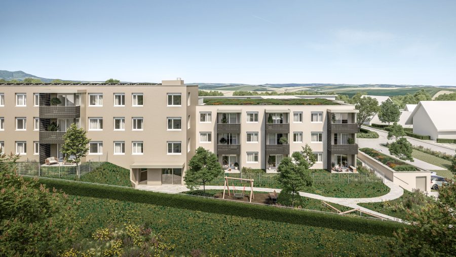 Moderne Wohngebäude mit Balkonen und grünem Außenbereich an einem sonnigen Tag in einer ruhigen Nachbarschaft.