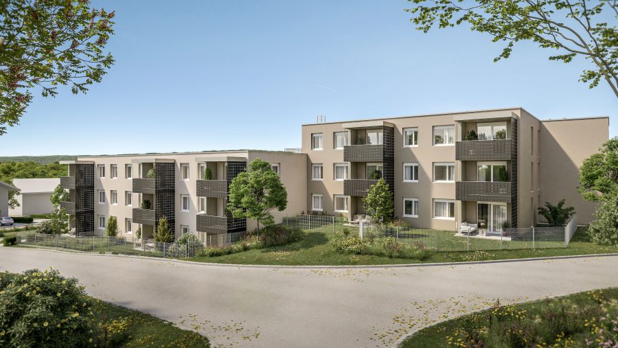 Moderne Wohngebäude mit Balkonen in einer grünen Umgebung bei sonnigem Himmel.