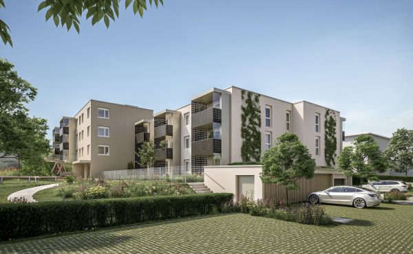 Moderne Wohnanlage mit Grünflächen und geparkten Autos an einem sonnigen Tag.