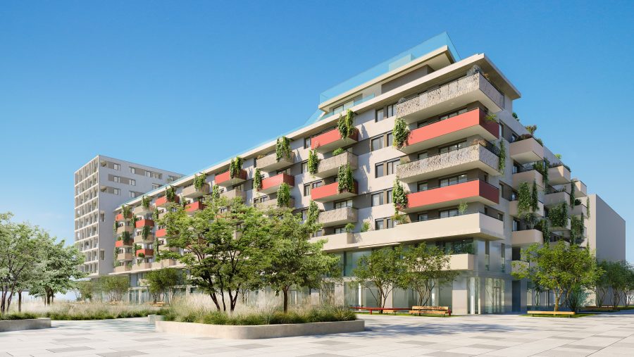 Moderne Wohnanlage mit Balkonen und Bäumen in einer städtischen Umgebung bei klarem Himmel.