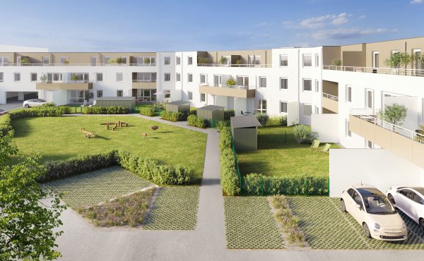 Moderne Wohnanlage mit grünem Innenhof, Parkplatz und Balkonen unter blauem Himmel.