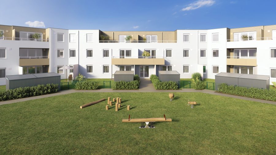 Mehrstöckiges Wohnhaus mit grünem Innenhof und Spielbereich an einem sonnigen Tag.